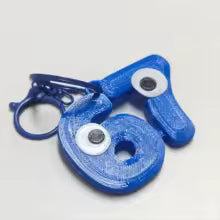 Søt 67-nøkkelring med øyne